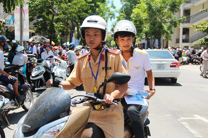 Chiến sĩ Phòng CSGT Công an TP Đà Nẵng đưa, đón thí sinh đi thi - Ảnh: Phan Thành