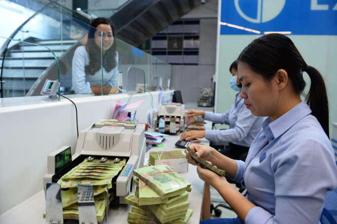 Hiện lãi suất huy động và cho vay đã nhích lên. Các ngân hàng cũng hạn chế cố định lãi suất cho vay kỳ hạn dài. Trong ảnh: giao dịch tại Eximbank - Ảnh: Thuận Thắng