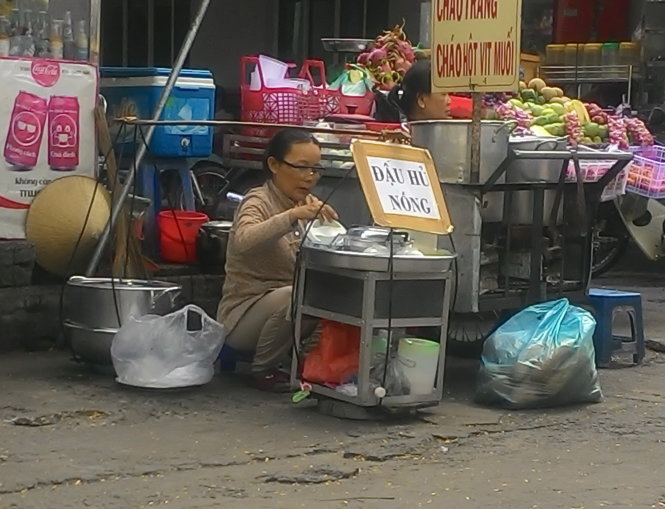 Bà Lê Thị Duông bên gánh tàu hủ. Nhờ gánh tàu hủ này mà bà nuôi con gái học nghề y sĩ - Ảnh: Q.Phương