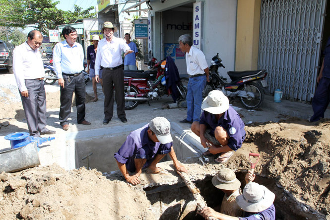Ông Lê Văn Hưởng (phải, chủ tịch UBND tỉnh Tiền Giang) chỉ đạo thi công hơn 10km đường ống cấp nước sạch cho hơn 5.000 hộ dân xã Phước Trung, Tăng Hòa (huyện Gò Công Đông) ngay tại hiện trường. Ông yêu cầu trong 10 ngày dân phải có nước ngọt sử dụng - Ảnh: V.Trường