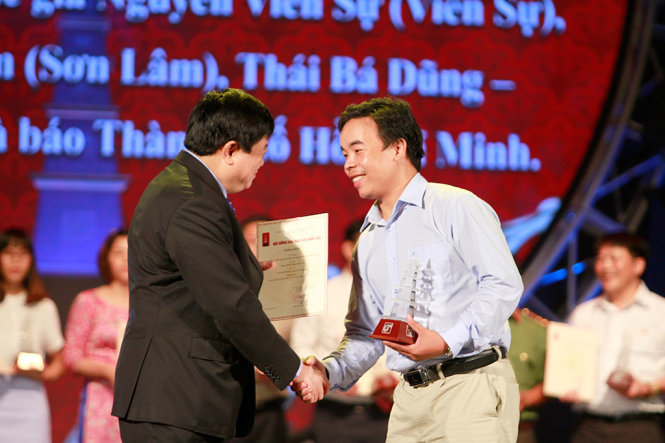 Phóng viên Thái Bá Dũng thay mặt nhóm tác giả báo Tuổi trẻ nhận giải C với loạt bài Những câu chuyện bên đường bên giới - Ảnh: NAM TRẦN