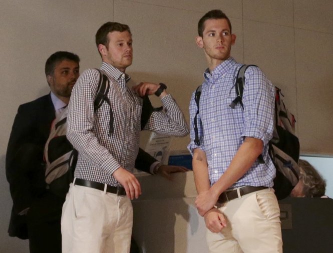 Hai kình ngư Jack Conger (trái) và Gunnar Bentz đang làm thủ tục lên máy bay trở về nước. Ảnh: REUTERS