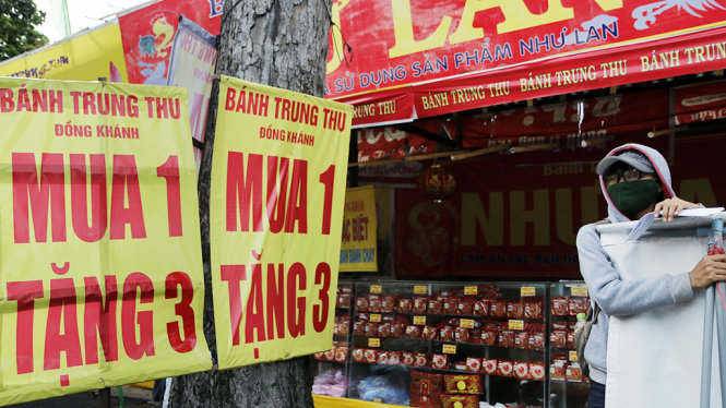 Một quầy hàng bán bánh trung thu trên đường 3-2 (Q.10, TP.HCM) đưa ra chương trình giảm giá mua 1 tặng 4 - Ảnh: NGỌC DƯƠNG