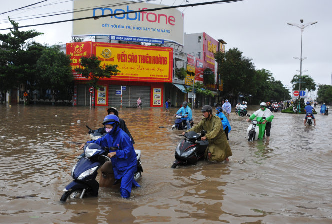 Đường Trần Hưng Đạo, trục đường chính của TP Tuy Hòa ngập sâu. Tại điểm giao nhau với đường Hùng Vương nhiều người đi xe phải dắt xe vì bị chết máy - Ảnh: Nhóm ảnh của Dương Thanh Xuân