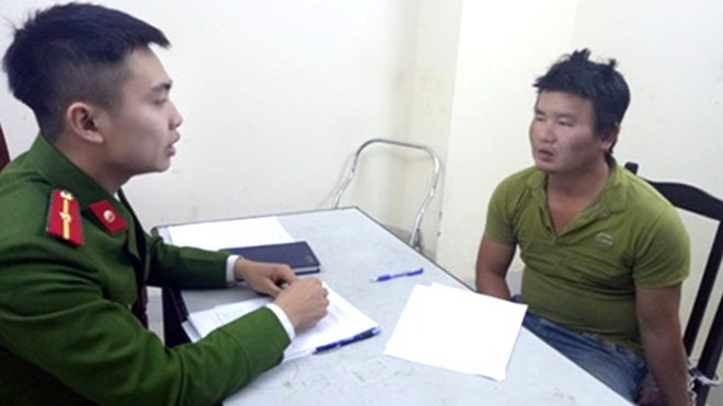Nghi can Phạm Thế Loát tại Công an quận Đống Đa - Ảnh: T.Q