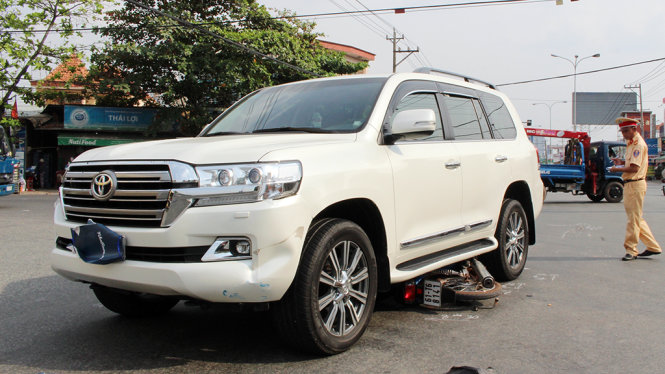 Sau khi gây tai nạn, tài xế xe ô tô 7 chỗ đã xuống dùng vải che kín biển số - Ảnh: ĐÌNH TRỌNG