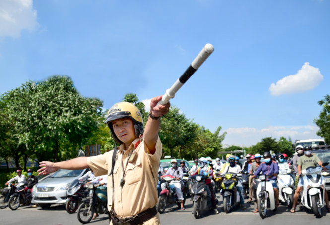 CSGT hướng dẫn các phương tiện tham gia giao thông trước cổng vào sân bay Tân Sơn Nhất, một trong những điểm kẹt xe căng thẳng tại TP.HCM - Ảnh: HỮU THUẬN