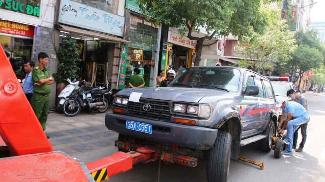 Sau khi niê phong xe cẩu tiến hành cẩu xe biển số xanh về phường - Ảnh: Tâm Đức