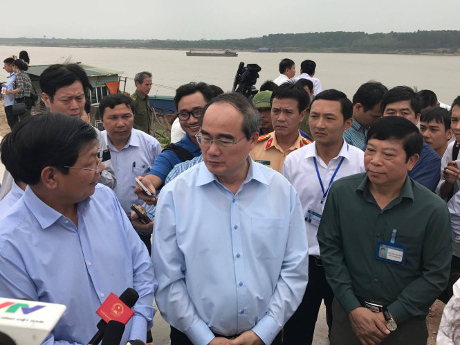 Ông Nguyễn Thiện Nhân, chủ tịch Uỷ ban Mặt trận Tổ quốc Việt Nam trao đổi với một chủ bãi tập kết cát - Ảnh: Xuân Long