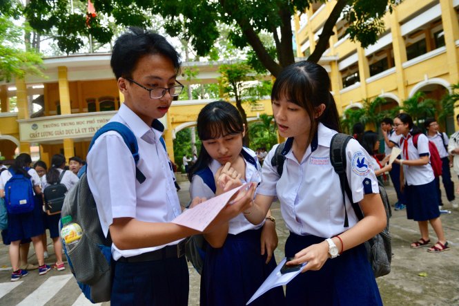 Các em học sinh trao đổi đáp án sau khi kết thúc môn Ngoại ngữ tại hội đồng thi Trường THPT Trưng Vương (Q.1) - Ảnh: Duyên Phan