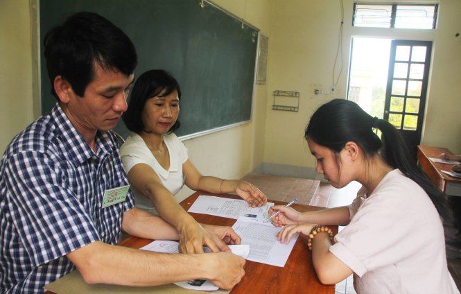 Giám thị đối chiếu thẻ dự thi của thí sinh tại điểm thi Trường THPT chuyên Phan Bội Châu, Nghệ An - Ảnh: Doãn Hòa