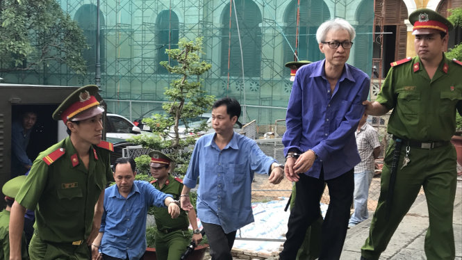 Bị cáo Lê Dũng (bên phải) và đồng phạm được dẫn giải tới tòa - Ảnh: Tuyết Mai