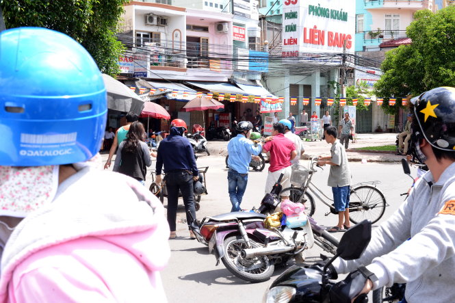 Một người đi đường phải can thanh niên không đội mũ bảo hiểm khi người này nhảy vào đánh người đàn ông lớn tuổi sau vụ va quẹt xe máy trên đường Điện Biên Phủ (TP.HCM) - Ảnh: T.T.D.
