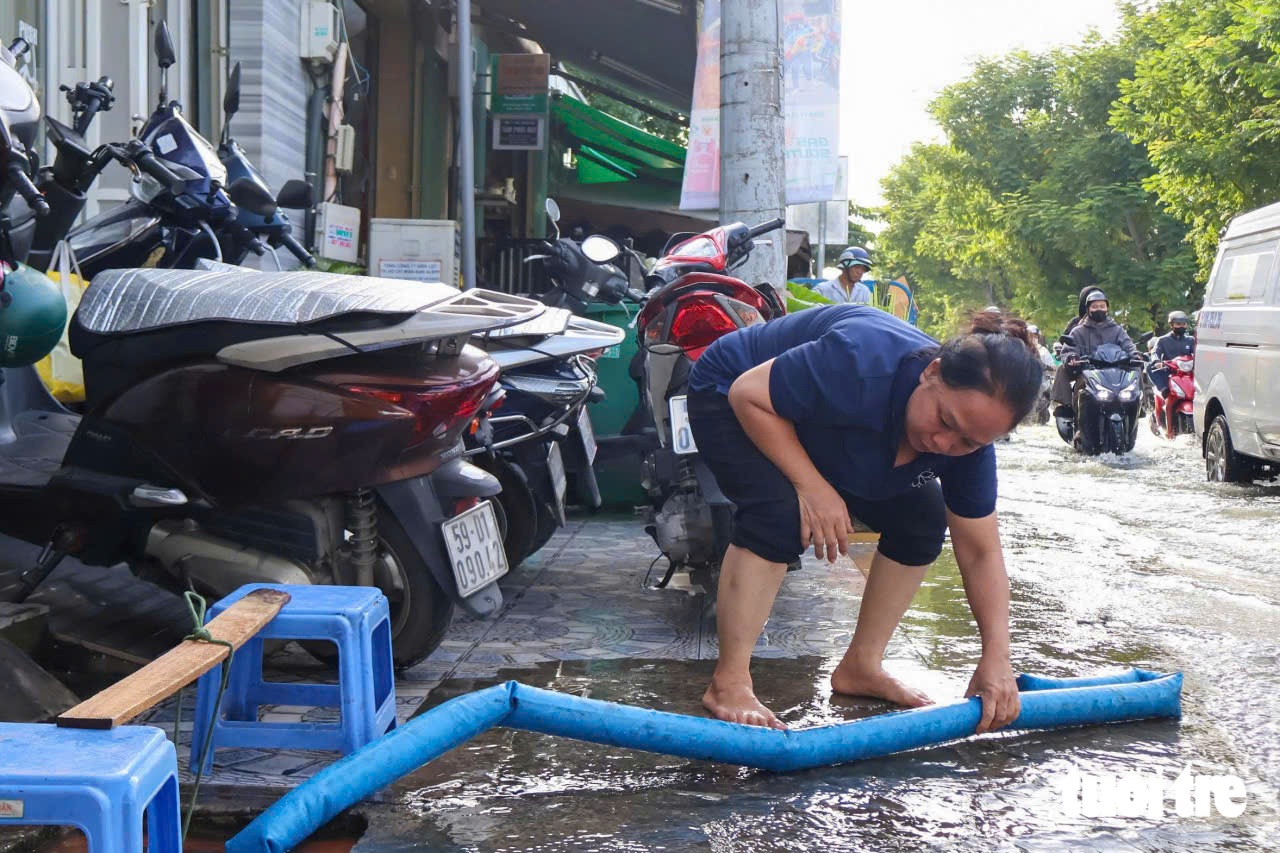 Ho Chi Minh City streets flooded as tide reaches 1.71m - Ảnh 10.