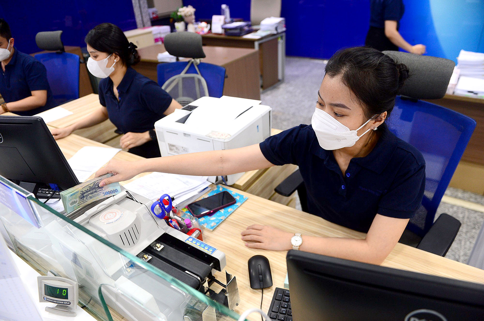 Ngân hàng giảm lợi nhuận, hạ lãi suất cho vay - Ảnh 1.