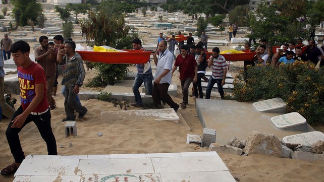 Palestinians carry the bodies of some of the eight members of Abu Jarad family who were killed overnight in an Israeli strike