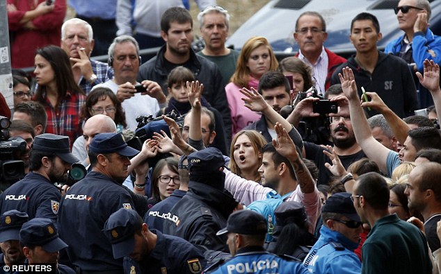 Spanish police block animal rights activists protesting outside the apartment building of Mrs Romero Ramos
