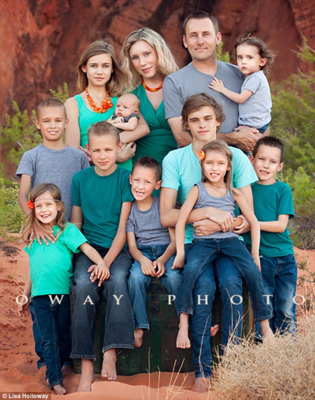 Family matters: Ms Holloway pictured with her husband and all ten children&nbsp;