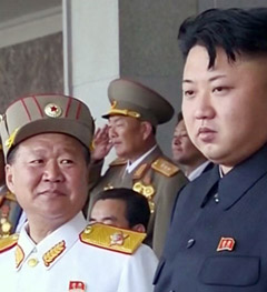 Choe Ryong-hae (left) smiles at North Korean leader Kim Jong-il during a military parade in Pyongyang in July last year. 