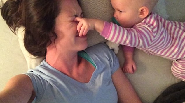 No shut eye: Baby tries poking mommys eyes so that she wakes up to play with her