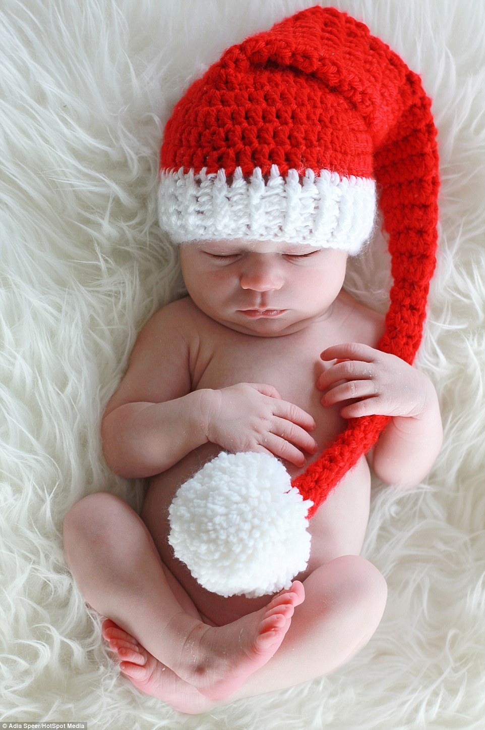 Varying from one to three hours for each photoshoot, Adia photographs the youngsters in Santa hats, munching on Christmas carrots and even posed in a little Christmas baskets. In this picture,&nbsp;Vera, under two weeks old, looks adorable wearing this woolly Santa hat