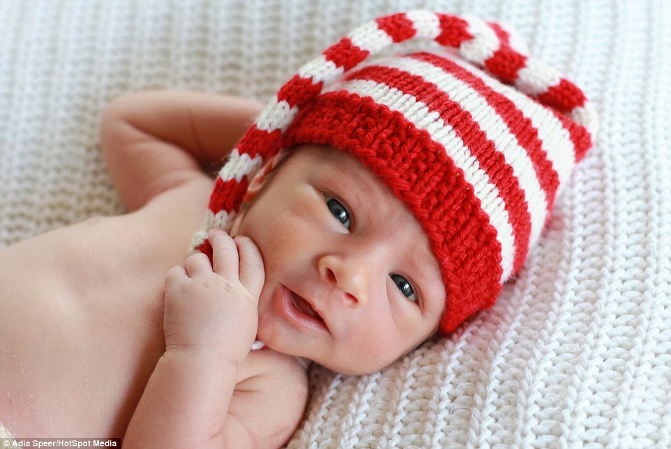 Adia says: Not all newborns like to be swaddled or tolerate being put into a basket. In this picture Brayden, under two weeks old, opens his eyes as he shows off his Christmas hat