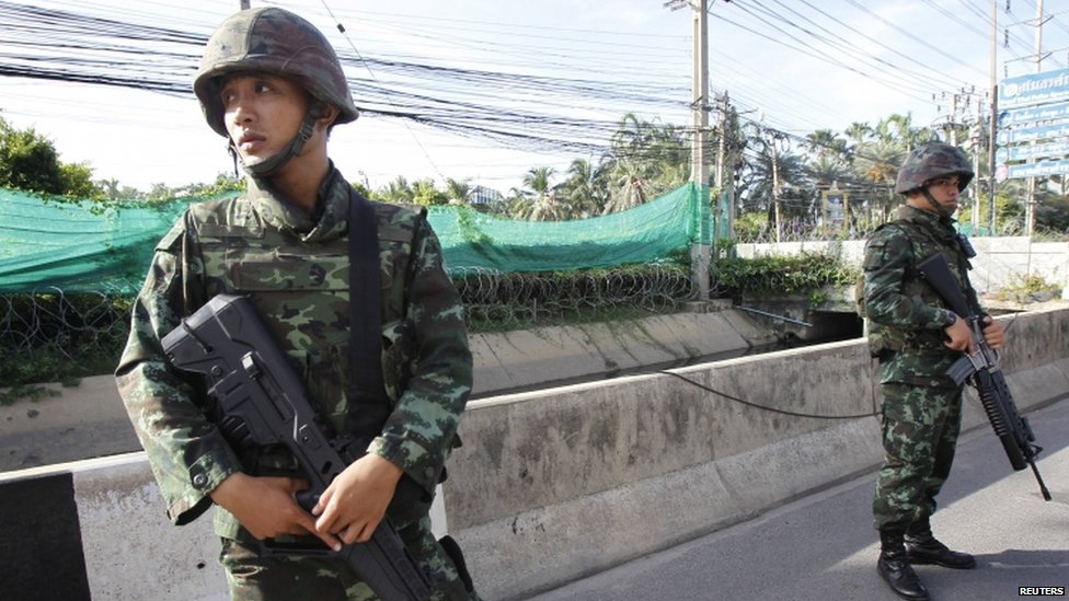 Thai soldiers take up a position on a main road in Bangkok following the imposition of martial law