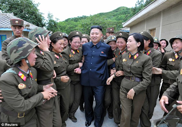 With the ladies: North Korean dictator Kim Jong Un with female members of the Korean Peoples Army Unit 4302 in an undated picture. Many of the artillery units along the coasts are manned with women