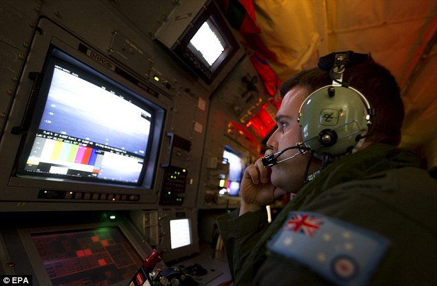 Scouring the ocean: Royal Australian Air Force airborne electronics analyst Sergeant Samuel Carson uses the advanced camera systems on board an AP-C3 Orion aircraft to search for evidence of MH370