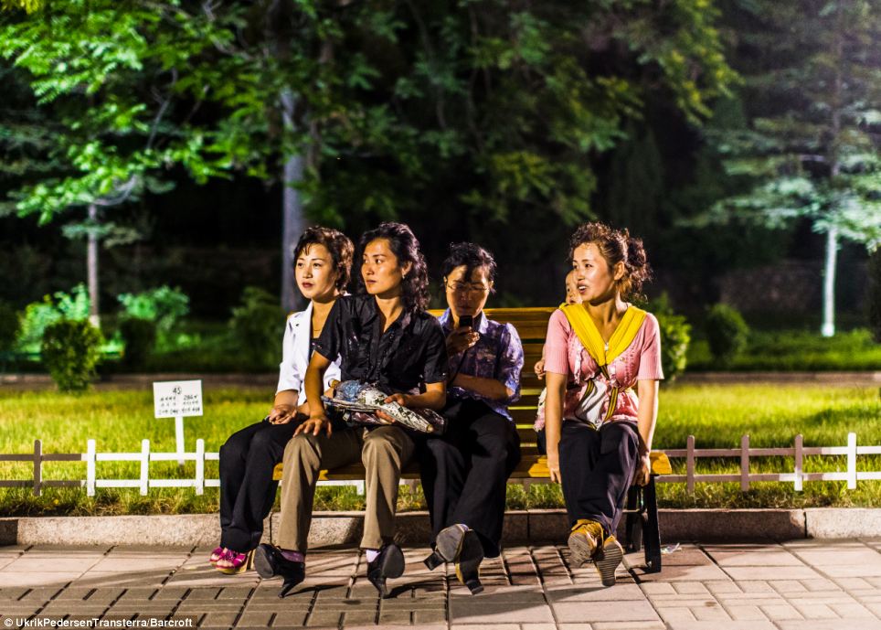 At first Pedersen was amazed to see people living normal lives - such as these women in a youth park in Pyongyang - but he quickly realised he was being deceived