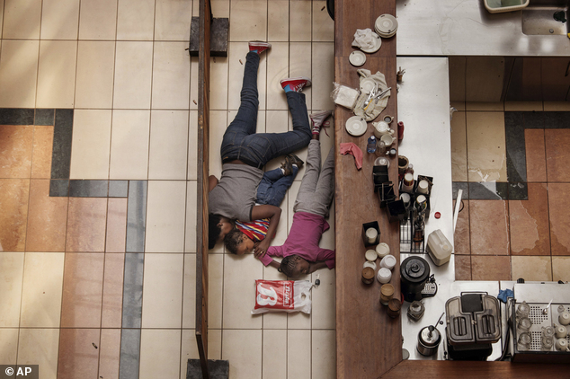In this photo provided on Friday Feb. 14, 2014 by World Press Photo, the 2nd prize in the Spot News Stories category of the 2014 World Press Photo Contest by...