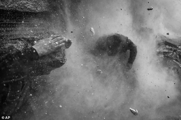 In this photo provided on Friday Feb. 14, 2014 by World Press Photo, the 1st prize in the Spot News Stories category of the 2014 World Press Photo Contest by...