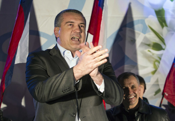 Crimeas Prime Minister Sergei Aksyonov (L) and parliamentary speaker Vladimir Konstantinov celebrate the time shift in the Crimean city of Simferopol March 30, 2014. (Reuters/Shamil Zhumatov)