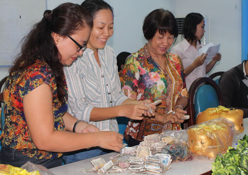 C&aacute;n bộ C&ocirc;ng đo&agrave;n quận B&igrave;nh Thạnh, TP HCM đập heo đất trong ng&agrave;y hội thu g&acirc;y Quỹ Học bổng Nguyễn Đức Cảnh