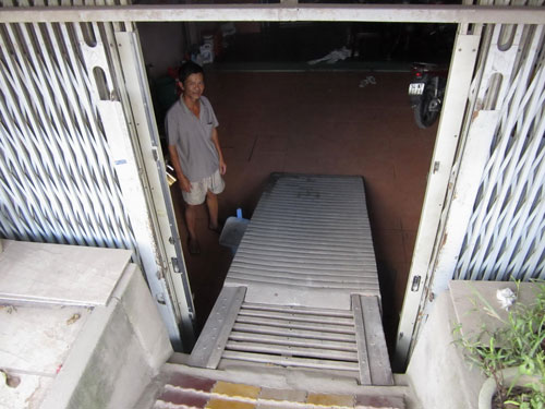 Sau khi Quốc lộ 50 n&acirc;ng đường, nh&agrave; &ocirc;ng Trần Nh&acirc;n Thanh (E10/285, ấp 5, x&atilde; Phong Ph&uacute;, huyện B&igrave;nh Ch&aacute;nh) thấp hơn mặt đường gần 2 m Ảnh: HO&Agrave;NG TRIỀU