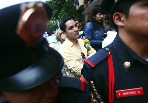 Người thanh ni&ecirc;n cầm hoa v&agrave;ng đứng trước cửa nh&agrave; Gabriel Garcia Marquez trong ng&agrave;y &ocirc;ng qua đời. Ảnh: Reuters