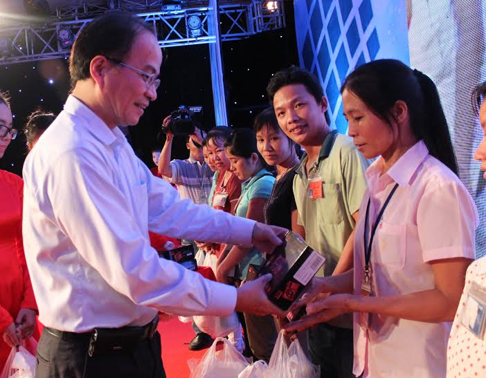 Ông Lê Mạnh Hà, Phó chủ tịch UBND TP HCM, trao radio cho CN ở trọ tại quận Thủ Đức Ảnh: THANH NGA