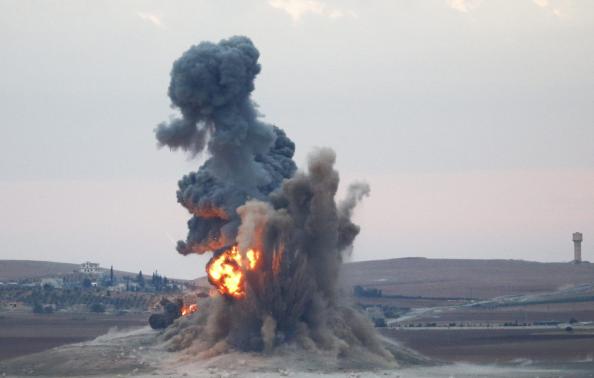 Smoke and flames rise over a hill near the Syrian town of Kobani after an airstrike, as seen from the Mursitpinar crossing on the Turkish-Syrian border in the southeastern town of Suruc in Sanliurfa province, October 23, 2014. REUTERS-Kai Pfaffenbach