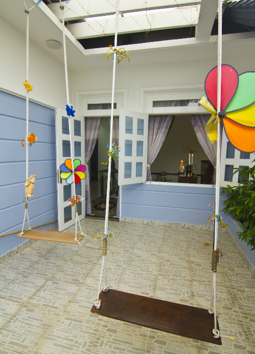 Khoảng s&acirc;n nhỏ cạnh ph&ograve;ng ngủ được bố tr&iacute; hai chiếc x&iacute;ch đu xinh xắn, điểm xuyến c&aacute;c chong ch&oacute;ng đa sắc.