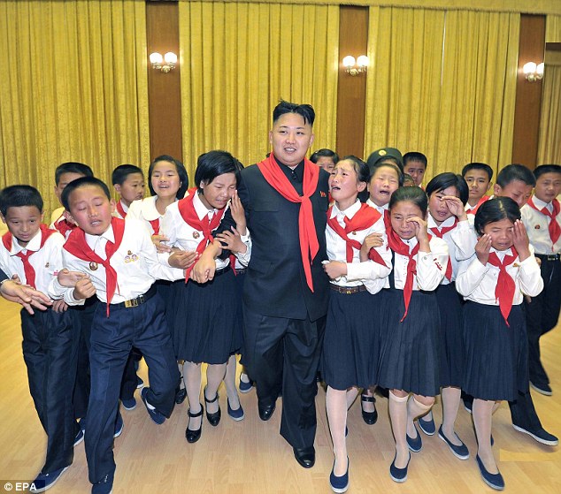 Crying children: Kim walks while flanked by sobbing members of the Korean Childrens Union (KCU) in 2012