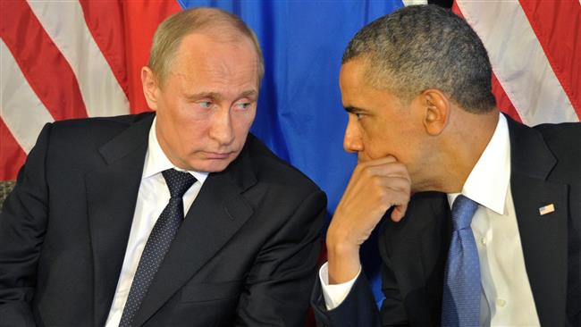 &Ocirc;ng Carter m&ocirc; tả c&aacute;ch h&agrave;nh xử của Tổng thống Nga Vladimir Putin (tr&aacute;i) l&agrave; h&agrave;nh vi th&ugrave; địch. Ảnh: Press TV
