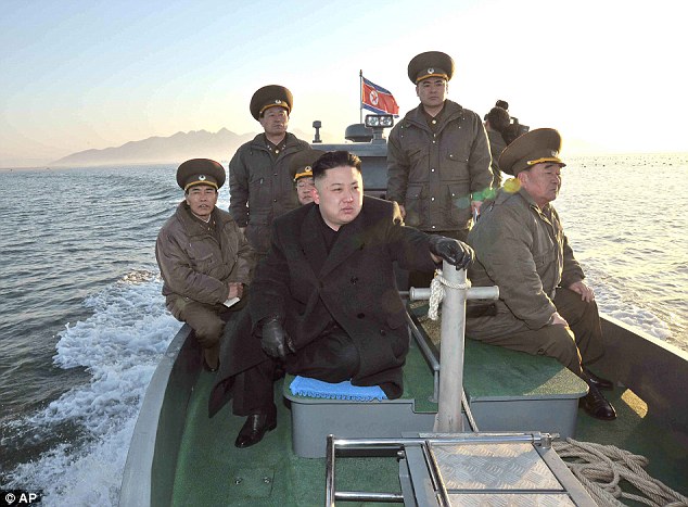 Maximum alert: Pictured on a boat near the western sea border with South Korea, Kim urged front-line troops to be on maximum alert for a potential war in March 2013