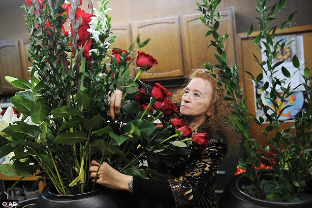 Marie Majusiak, owner of Watertown Flowers, works on a one of two flower arrangements ahead of President Barack Obamas visit