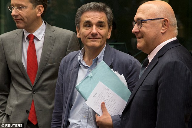 Naive: In only his second day in the job, Tsakalotos (centre) posed for photographs alongside Dutch finance minister and Eurogroup president, Jeroen Dijsselbloem (left) but failed to conceal his notes