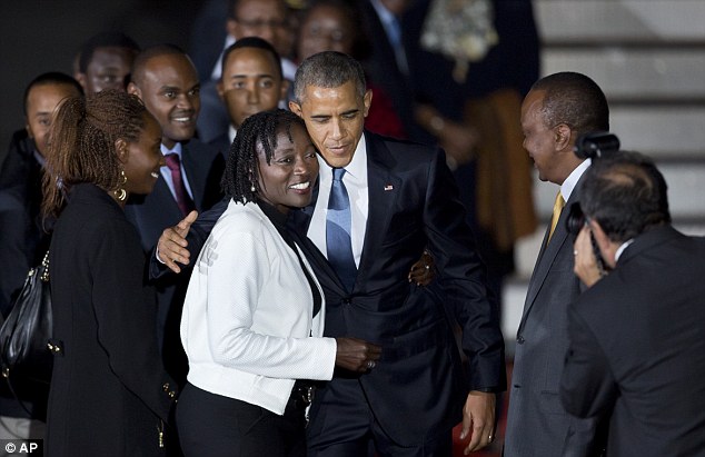 Family reunion: Obama is pictured above at Bairobis airport hugging Auma, who met him along with the Kenyan president, Uhuru Kenyatta, right in a yellow tie