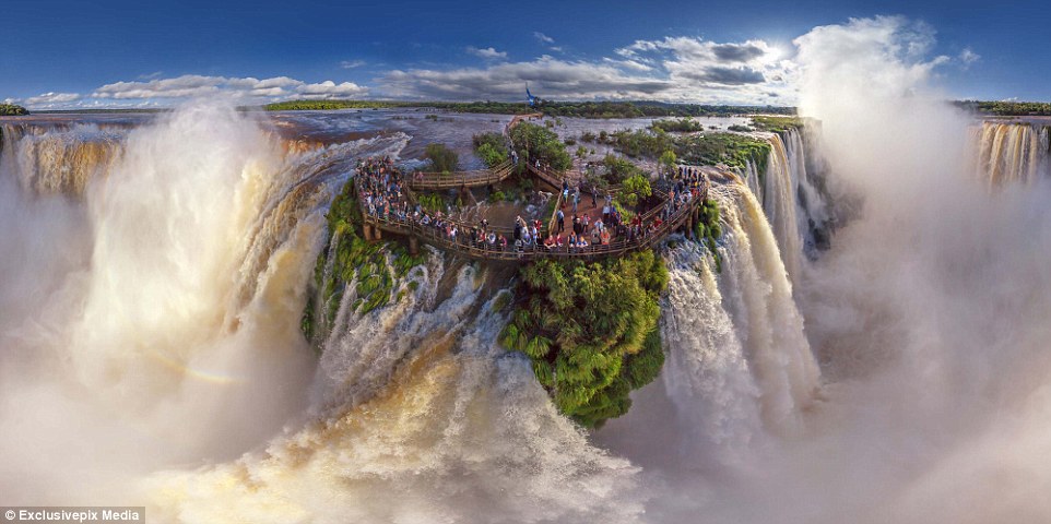 Iguazu Falls on the border of Brazil and Argentina: People gather on a viewing platoform to marvel at the staggering power of the falls
