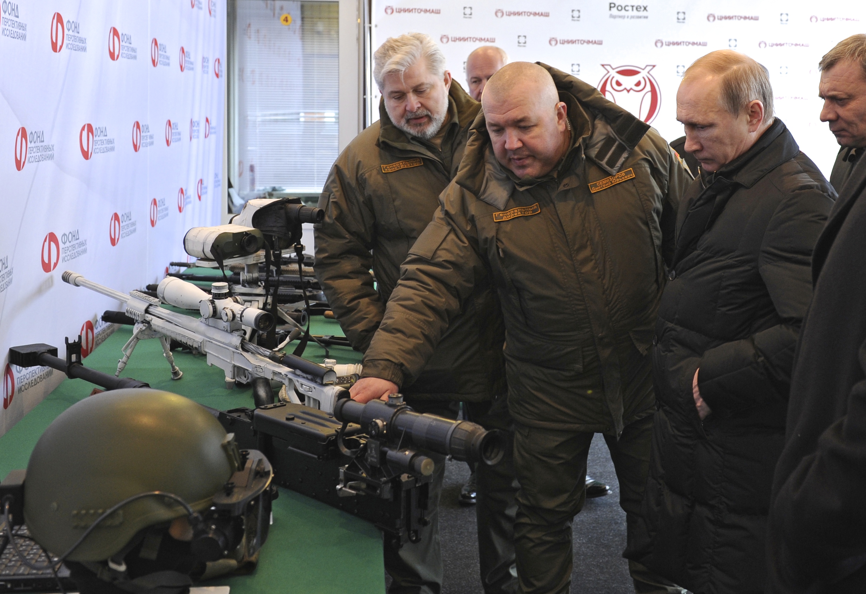 Russian President Vladimir Putin, right front, visits the Central Scientific Research Institute of Precise Mechanical Engineering in Klimovsk, near...