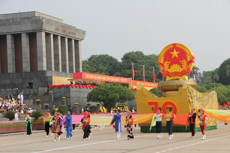 Dẫn đầu đo&agrave;n diễu h&agrave;nh l&agrave; Quốc huy nước Cộng h&ograve;a x&atilde; hội chủ nghĩa Việt Nam