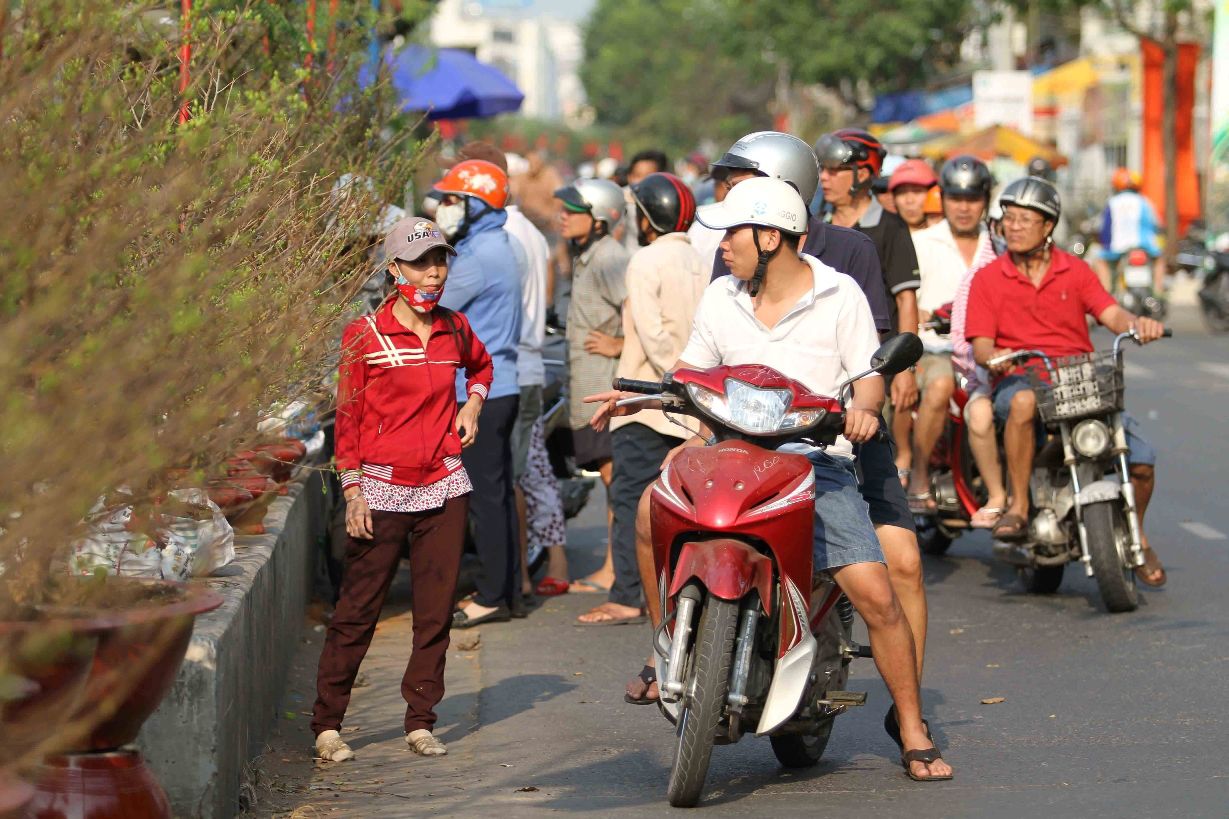 Hoa xếp th&agrave;nh d&atilde;y tr&ecirc;n con đường men dọc bờ k&ecirc;nh. Người d&acirc;n thường tranh thủ gh&eacute; v&agrave;o mua sắm v&agrave;i chậu kiểng chưng Tết