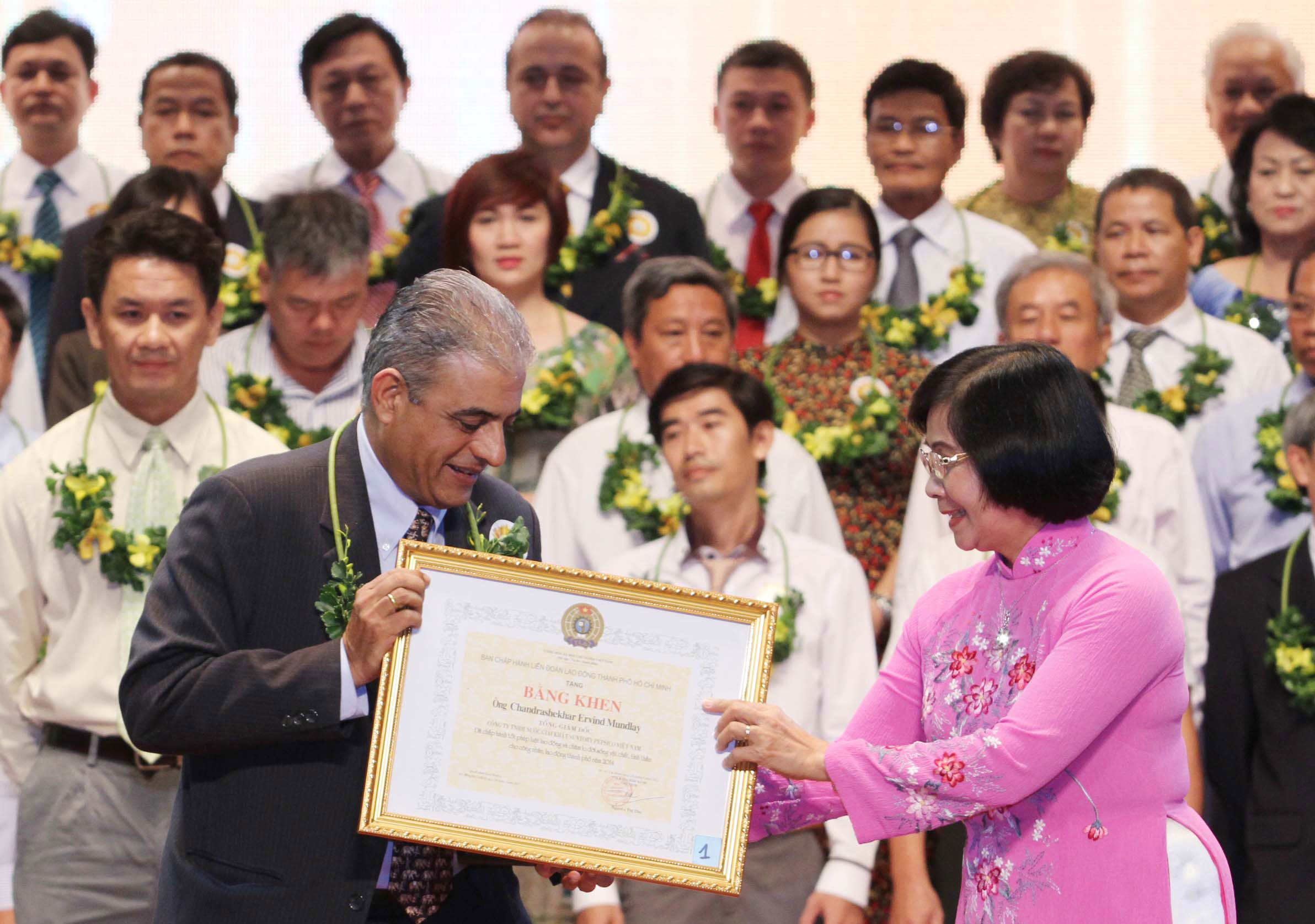 Bà Nguyễn Thị Thu Hà - Ủy viên Trung ương Đảng, Phó Bí thư Thành ủy TP HCM - tặng bằng khen cho lãnh đạo các doanh nghiệp Ảnh: HOÀNG TRIỀU